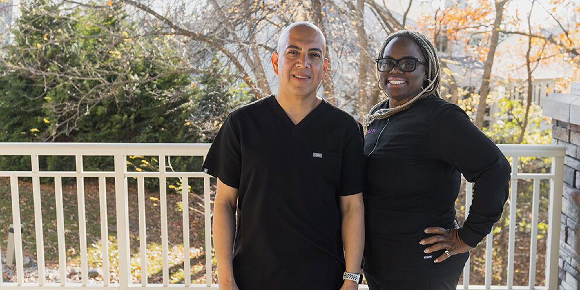 Doctor and staff member smiling for picture outside of the dental practice