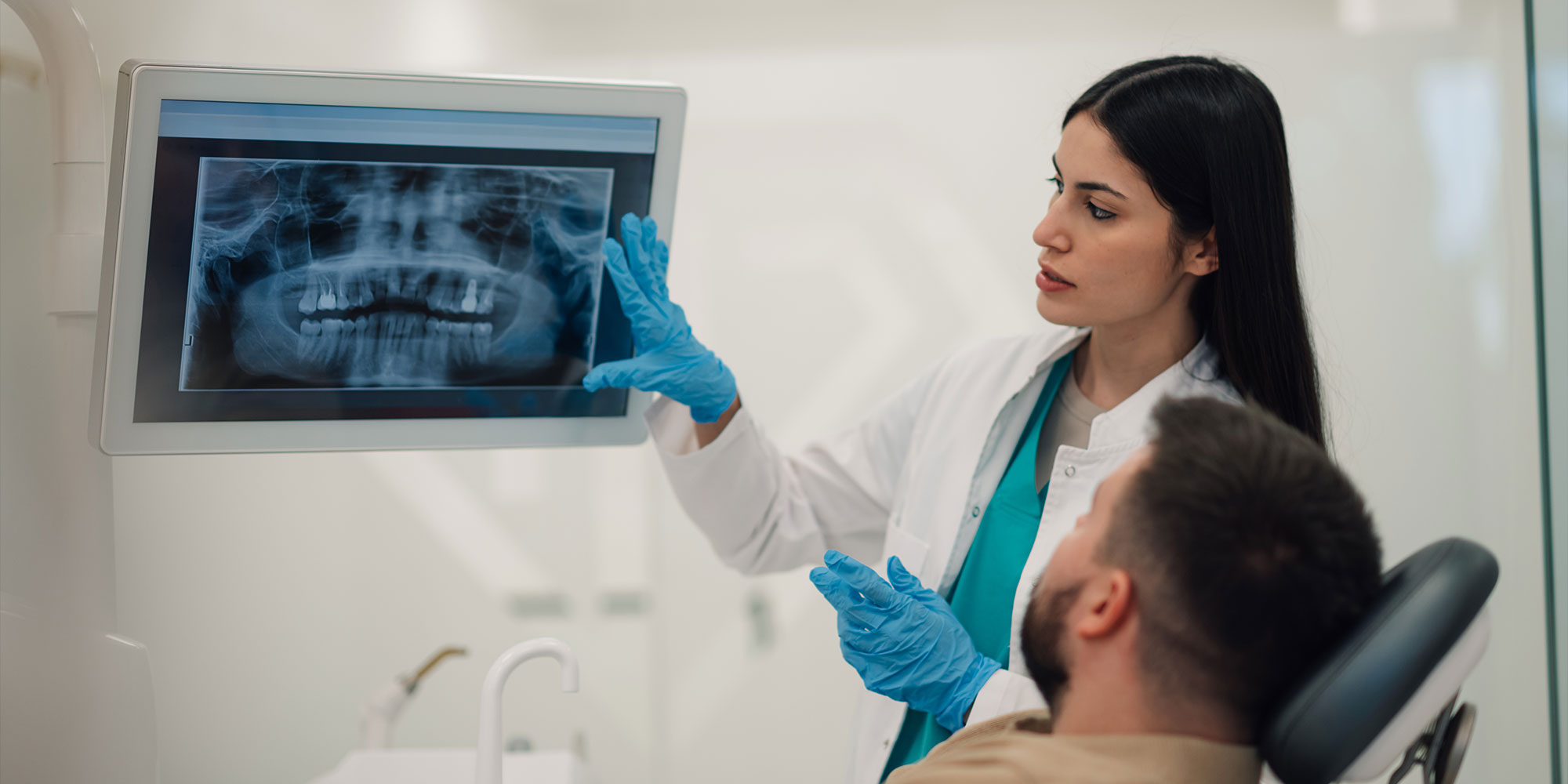 doctor showing patient dental procedure information