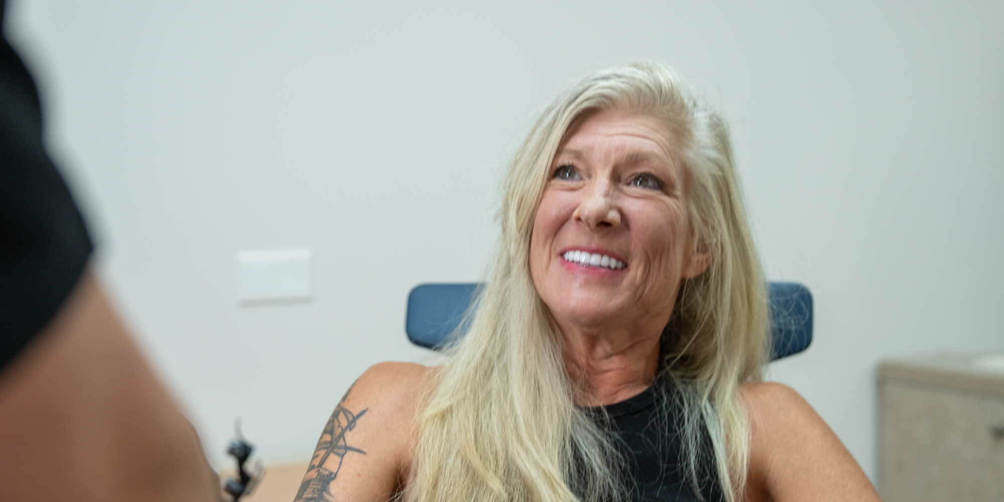 headshot of patient smiling brightly while in the dental center