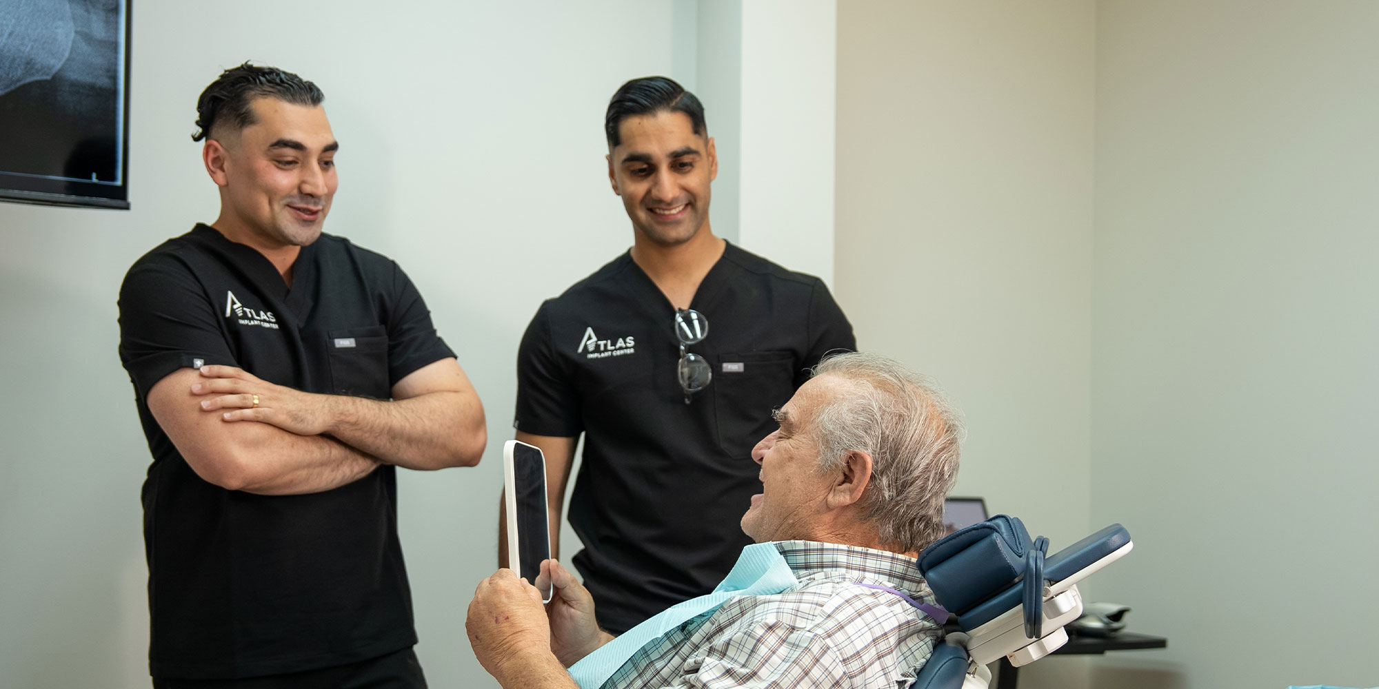 Doctors handing mirror ot patient